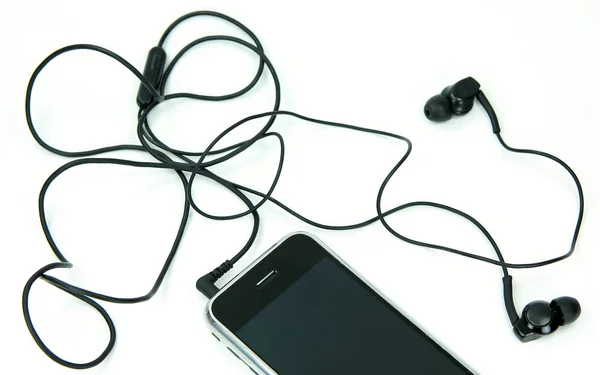 Earphones attached to smartphone — Stock Photo, Image