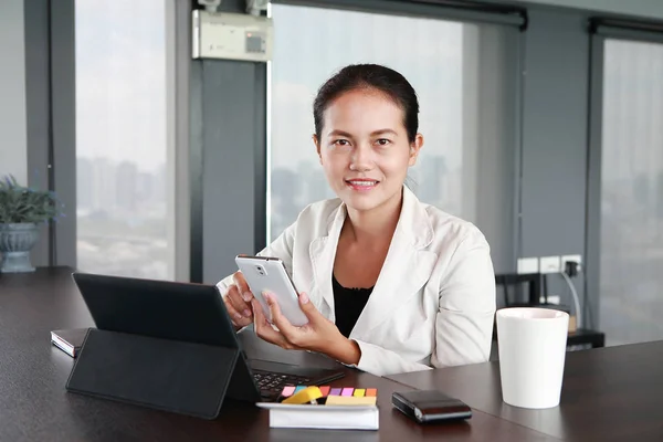 Young businessman sitting at the table on workplace in office with laptop computer and telephone — Stock Photo, Image