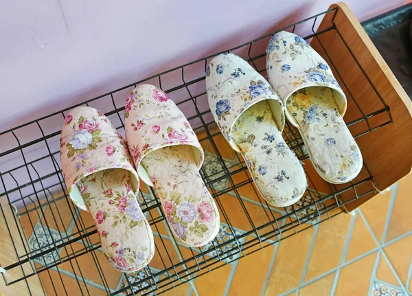 Two pairs of slippers on Shoe Rack — Stock Photo, Image