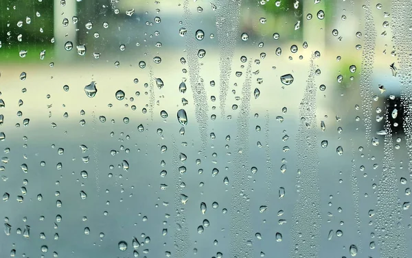 Abstract background, water drops on a window glass, rainy day — Stock Photo, Image