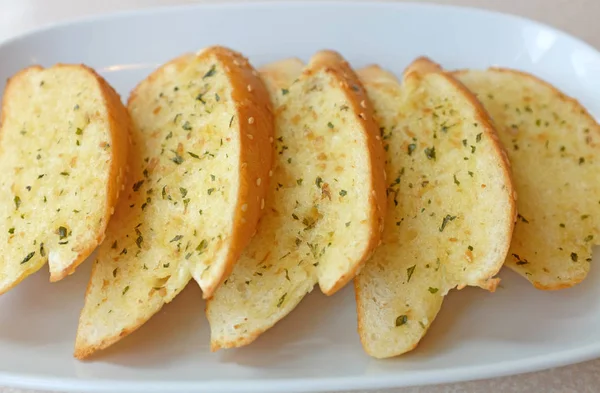 Home-made Garlic and herb bread slices on plate — Stock Photo, Image
