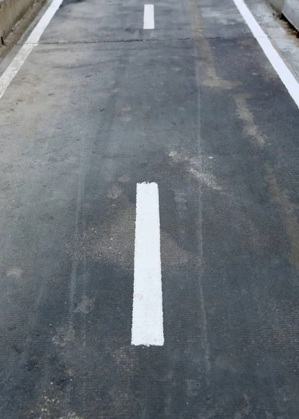 Asphalt with white dashed line