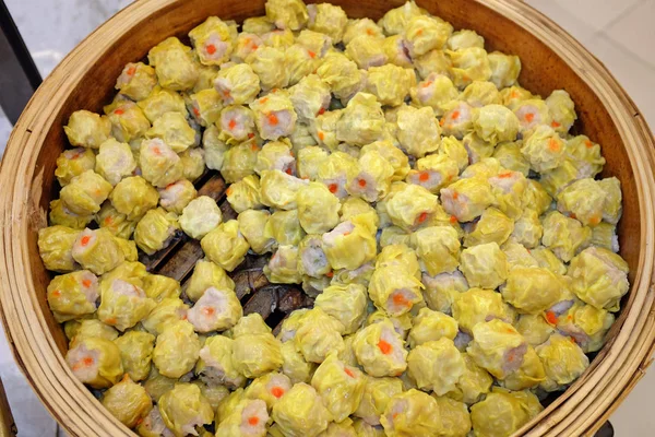 Traditional Chinese dumplings called "Dim Sum" steamed in the wooden containers. — Stock Photo, Image