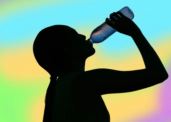 Dubbel exponering av törstig kvinna dricksvatten mot färgglada — Stockfoto