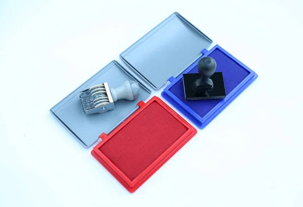 Rubber stamp and Red - Blue Ink cartridges on white background. — Stock Photo, Image