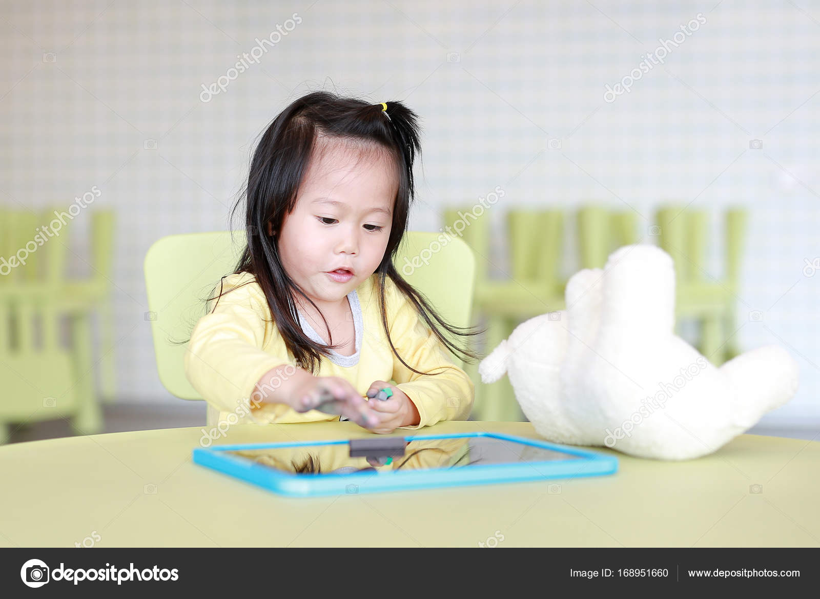 Little Asian Child Girl Playing Chalk On Blackboard In Kids