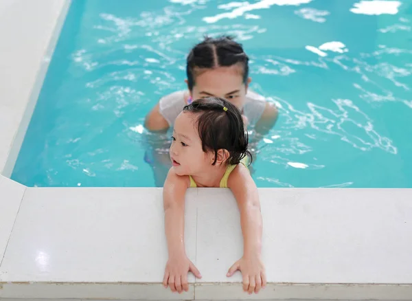 Familie der Mutter unterrichtet Kind im Schwimmbad — Stockfoto