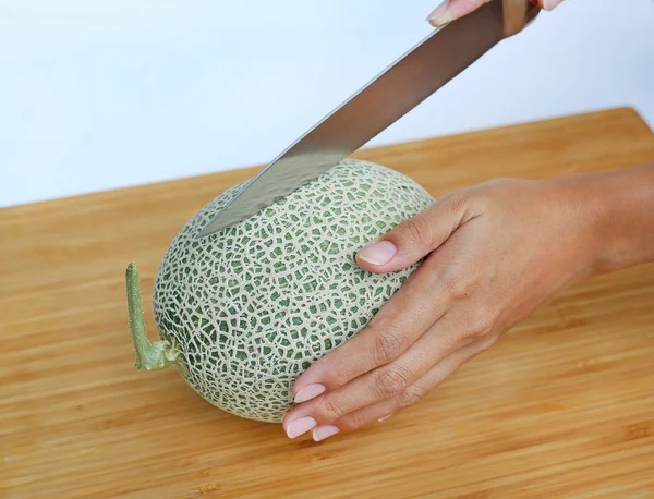 Cantaloupe Melone auf Holzbrett schneiden — Stockfoto