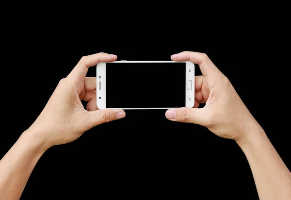 Mano celebración de teléfono inteligente móvil con pantalla en blanco. Concepto de fotografía móvil. Aislado en negro . — Foto de Stock