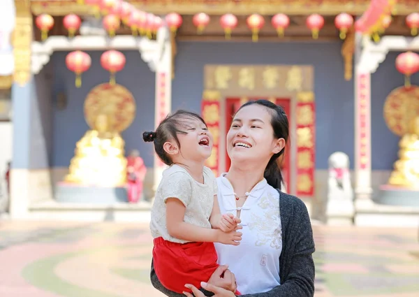 portrait of mother and cute little girl in Yaowarat Road (Bangkok chinatown) at Chinese new year