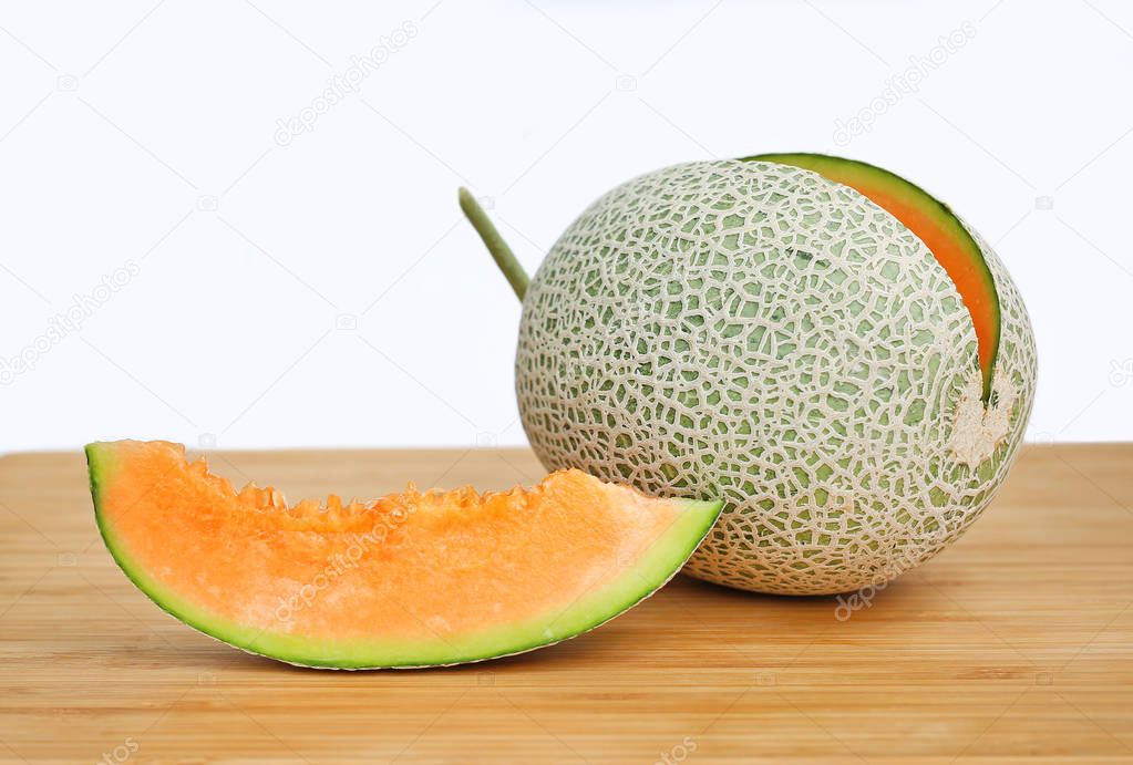 Sliced cantaloupe melon on wood board