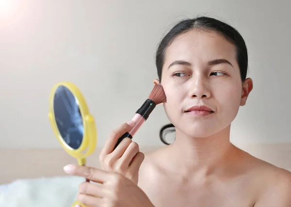 Beauty Girl with Makeup Brush.