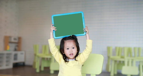 Cute Asian Child Girl Holding Empty Green Blackboard Playroom — Stock Photo, Image