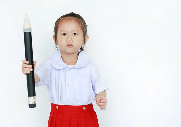 Portrait of asian child in school uniform holding big pencil isolated on white background.