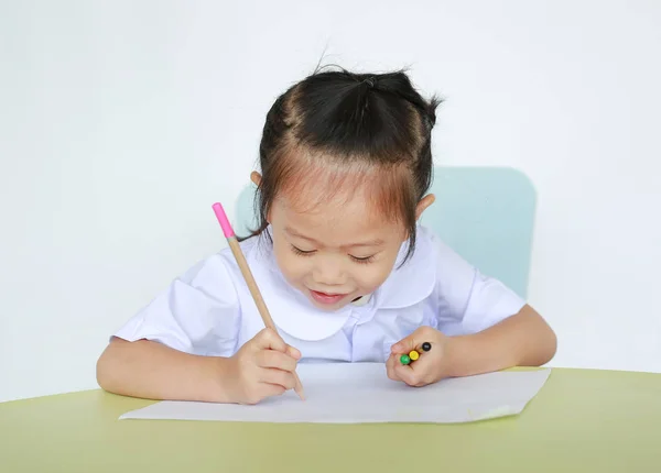 Asiatiska Barn Skoluniform Som Med Penna Som Skriver Tabell Isolerad — Stockfoto