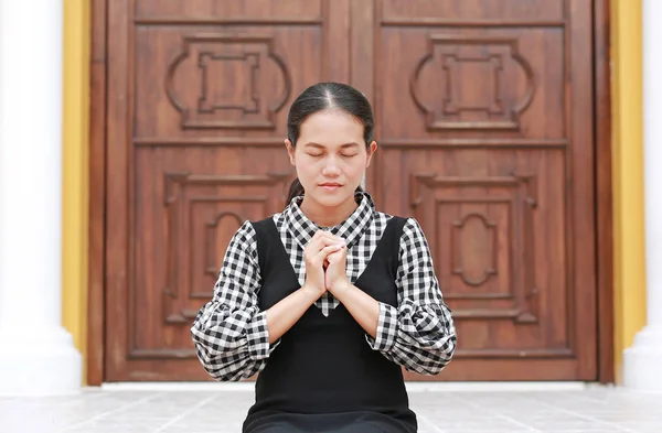 Asian woman praying at the church. Spiritual concept.