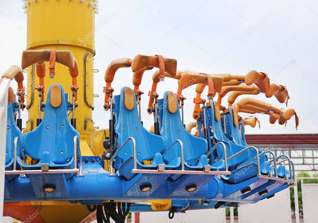 Empty seats of a thrilling ride at amusement park.