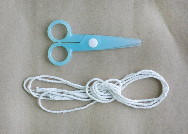 Cyan Plastic Children Safety Scissors Rope Place Brown Paper Background — Stock Photo, Image