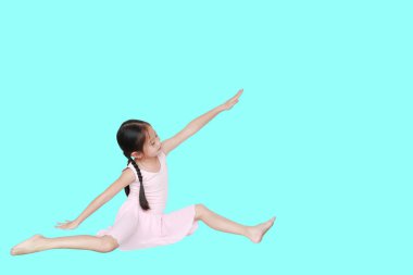 Asian little child girl dancer ballet ballerina stretching isolated on cyan background. Beautiful children in pink tutu skirt.