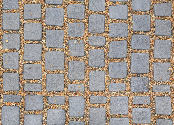 Pattern square stone pavement with gravel background. walking path textures.