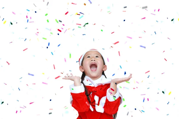 Šťastné dítě dívka v kostýmu Santa šaty s barevnými konfety r — Stock fotografie