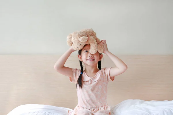 Smiling Asian Little Girl Showing Teddy Bears While Sitting Bed — Stock Photo, Image