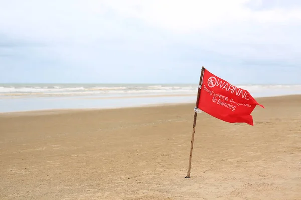 Red flag Warning Strong Current and Dangerous No Swimming in sea on Storm. Red flag flying on beach.