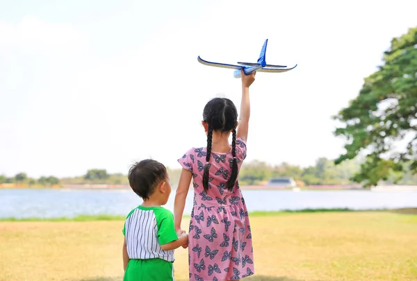 Asiatique Petite Fille Tenir Main Bébé Garçon Élever Avion Jouet — Photo