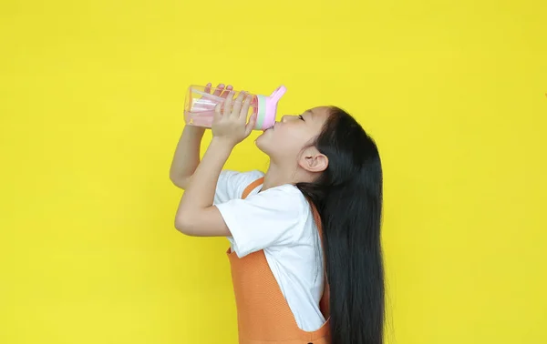 Thirsty Asian Child Girl Drink Water Tilted Plastic Bottle Isolated — Stockfoto