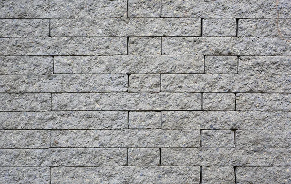 Grey stone tile texture brick wall background.