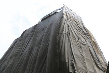 Siyah tuval ile kaplanmış inşaat halindeki bina