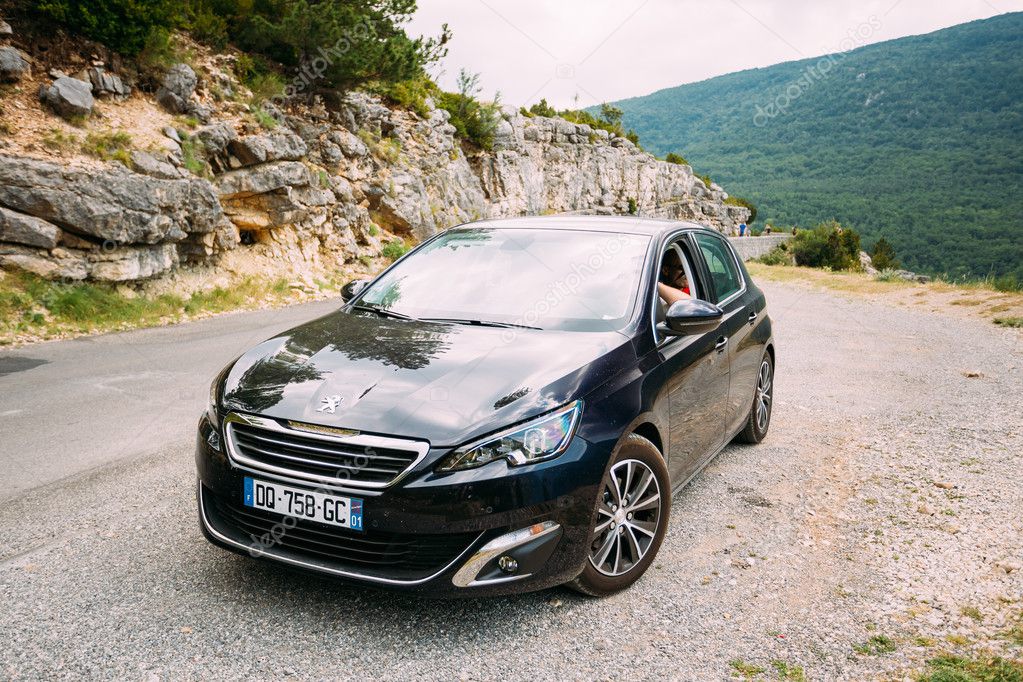 Black colour Peugeot 308 car on background of French mountain ... Black colour Peugeot 308 car on background of French mountain ...