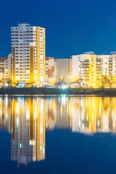 Night View Of Urban Residential Area Near City Lake Or River And Park