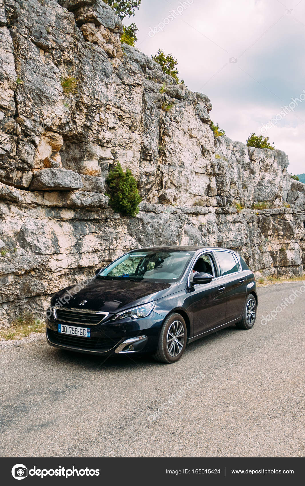 Black colour Peugeot 308 car on background of French mountain nature ... Black colour Peugeot 308 car on background of French mountain nature ...
