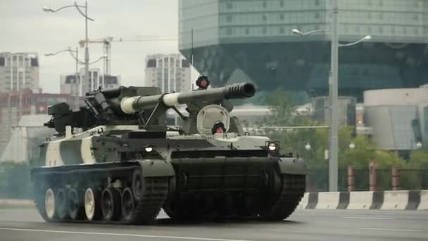Minszk, Fehéroroszország. Katonai önjáró fegyverek és Howitzerek a Nemzeti Könyvtár közelében mozognak a Fehéroroszországi Nemzeti Ünnepi Függetlenség Napjának megünneplése előtti próba alatt. — Stock videók