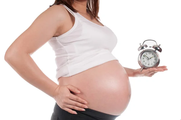 Pregnant Woman Holding A Clock Waiting For The Birth Royalty Free Stock Photos