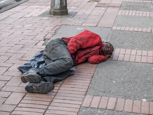 Sem-abrigo. Um sem-teto dormindo na rua Bogotá — Fotografia de Stock