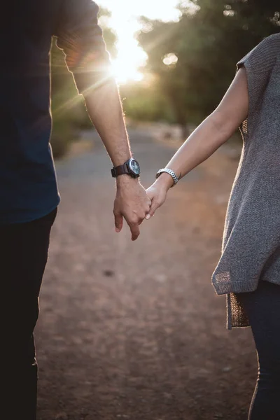 Couple holding hands along path Royalty Free Stock Images