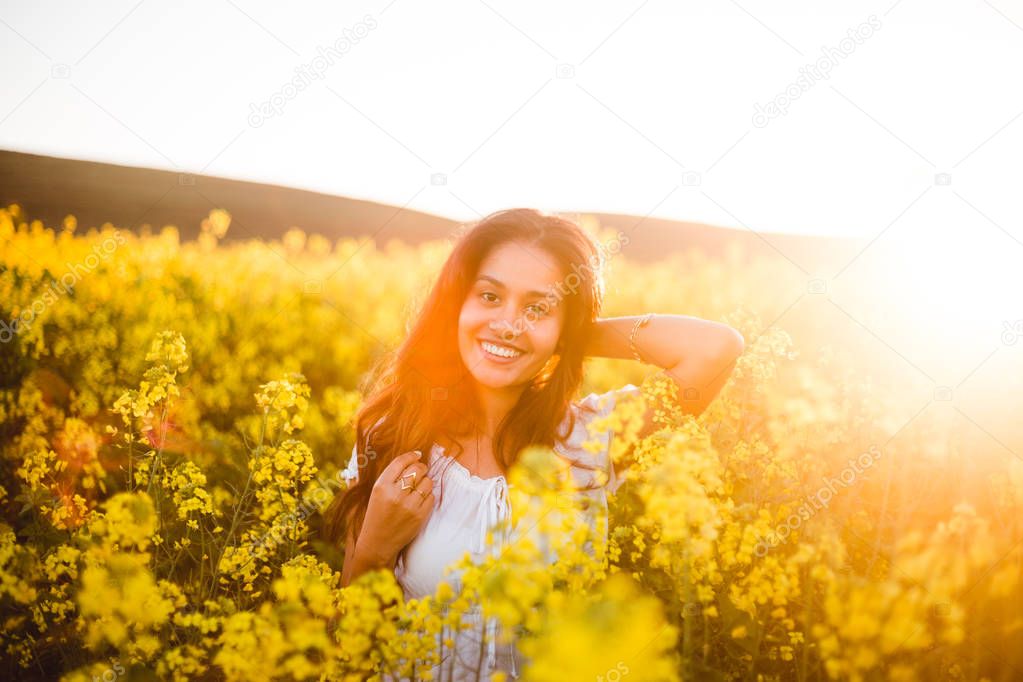 Teenage girl in yellow flowers field