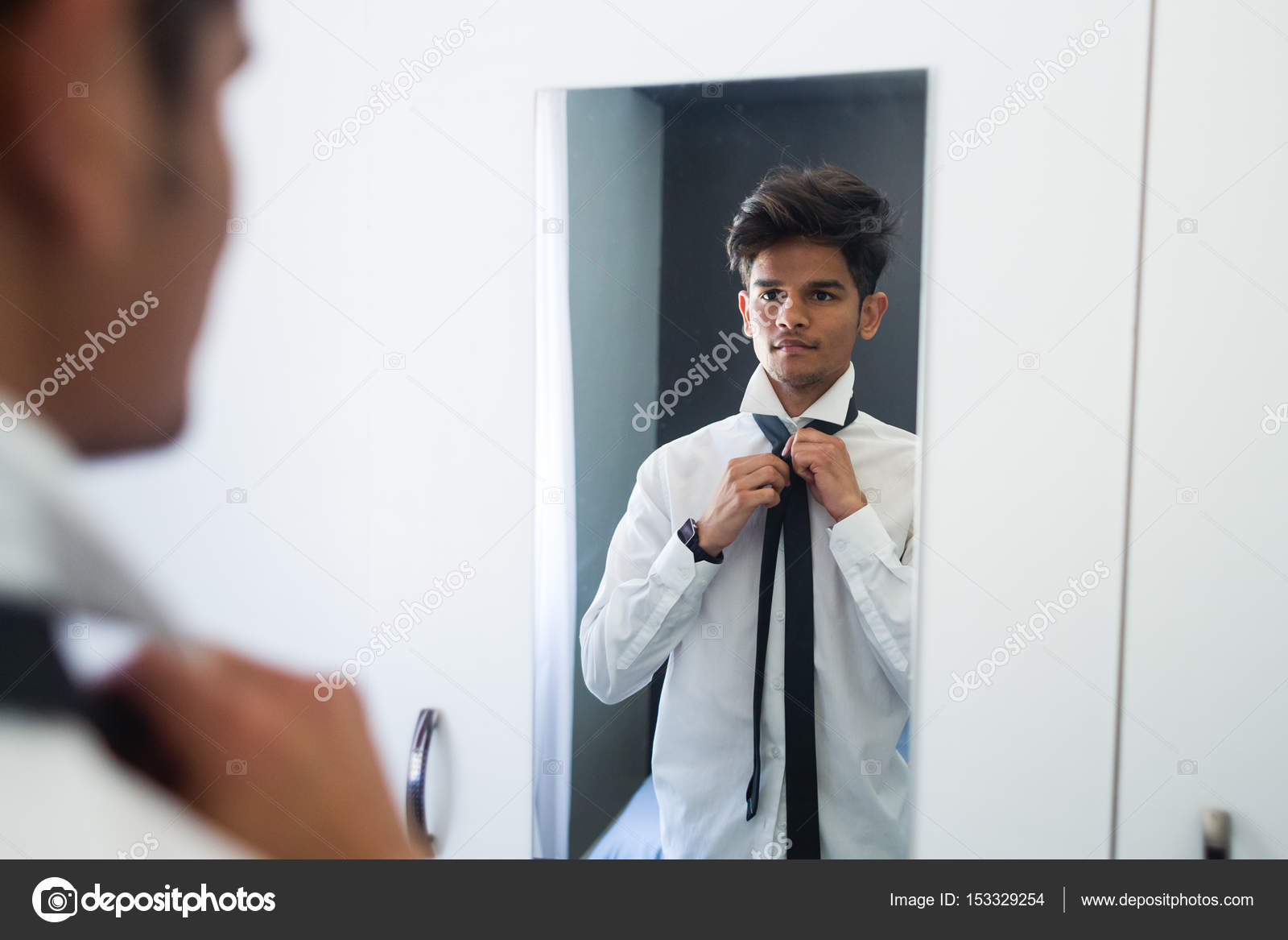 Man getting dressed in mirror Stock Photo by ©inlitestudio 153329254