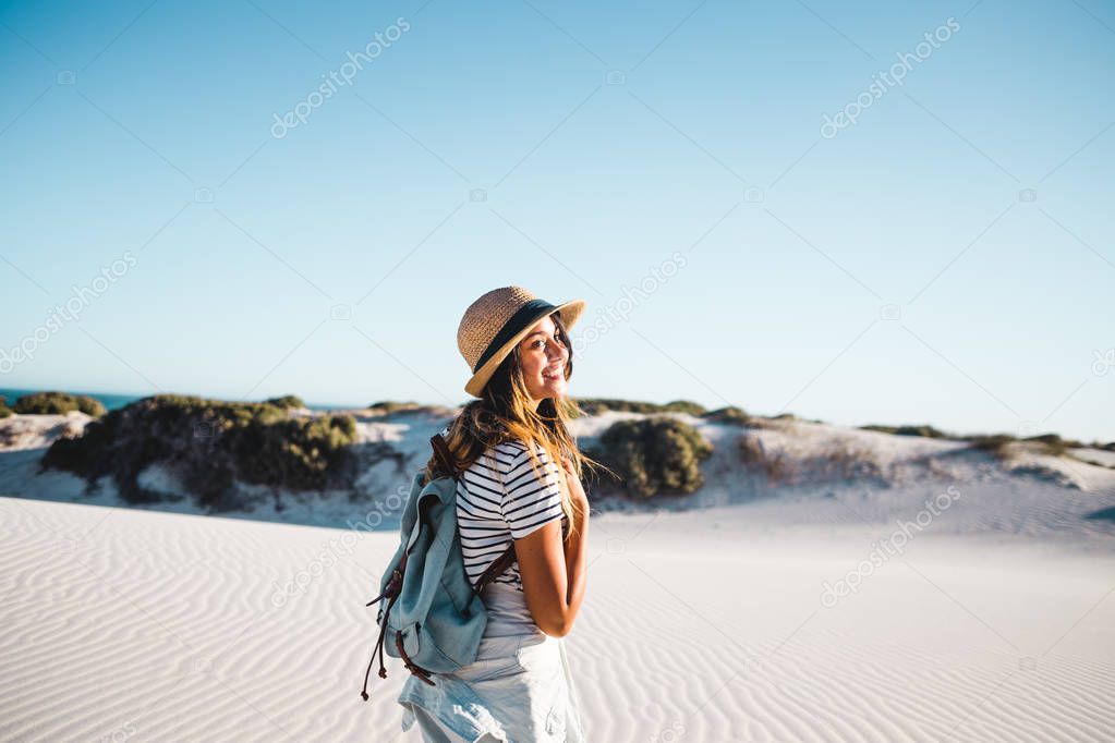 Young female exploring sandy beach