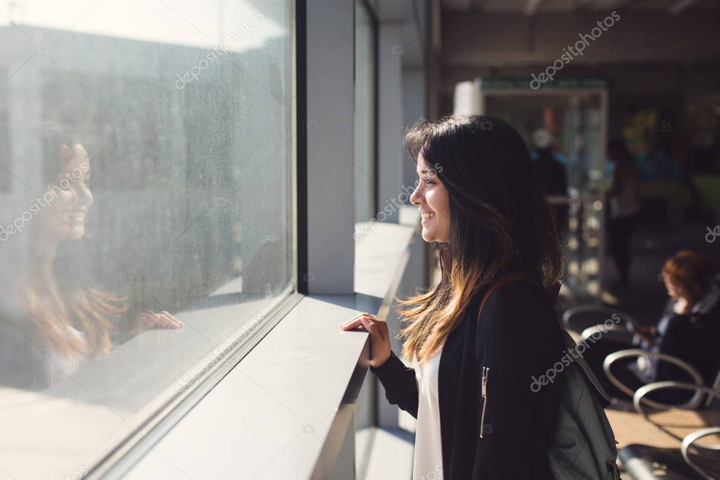 woman looking at window in airport