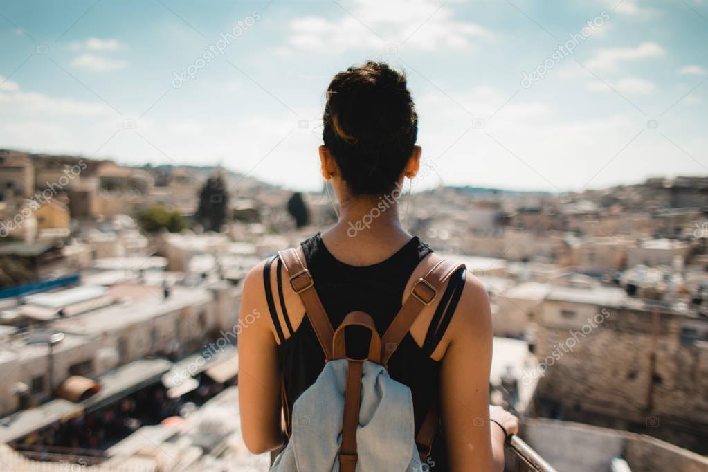 woman looking at old cityscape