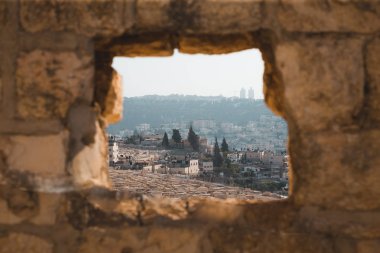 Hovels cityscape through hole in brick wall  clipart