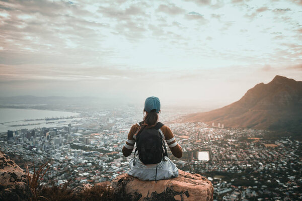 woman hiker in mountains above the city 