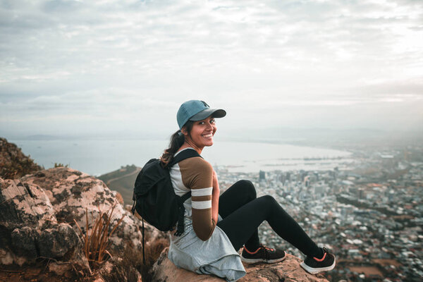 woman hiker in mountains above the city 