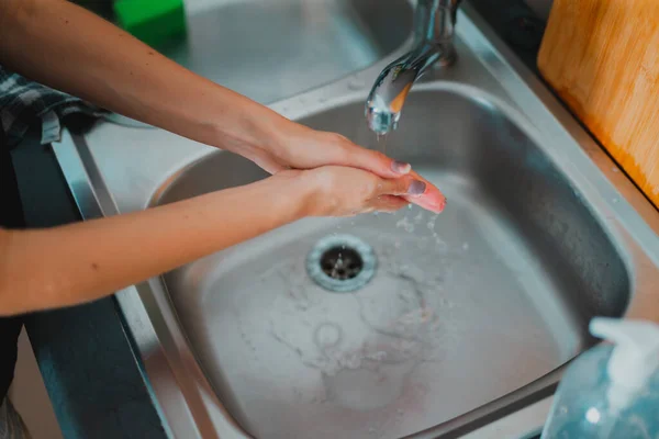 Young Person Washing Hands Using Sanitizer Stock Photo