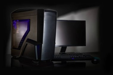 Black glowing computer for games, on a black background. clipart