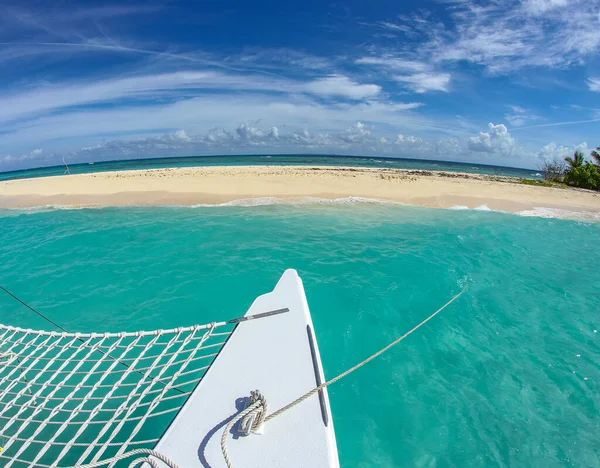 A catamaran is anchored at a small island off the coast of Puerto Rico.