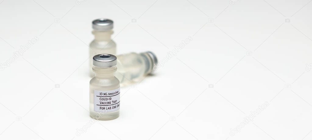 A pair of Covid-19 test vaccine vials isolated on a white background.